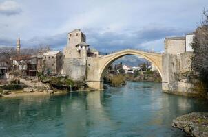 Visão do a velho ponte dentro Mostar cidade dentro Bósnia e herzegovina. Neretva rio. unesco mundo herança local. pessoas caminhando sobre a ponte. foto
