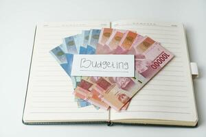 dinheiro em uma livro em uma branco fundo. rupia indonésio dinheiro. orçamento conceito. cópia de espaço foto