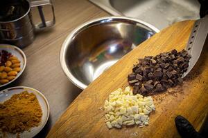 mulher cozinhando saboroso derretido chocolate em mesa dentro cozinha. foto