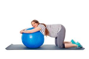 grávida mulher fazendo exercícios com exercício bola foto