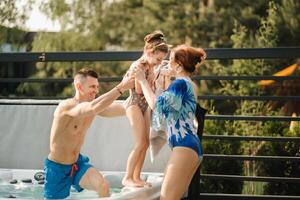 dentro verão, Papai leva a criança Fora do a ao ar livre piscina foto