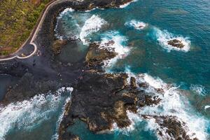rude rochoso falésias dentro a norte do tenerife.black de praia dentro a canário ilhas. rochas, vulcânico rochas, atlântico oceano foto