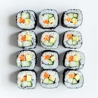 ai gerado topo Visão do sortido Sushi rolos ordenadamente arranjado em uma branco superfície, ideal para culinária temas e japonês cozinha relacionado conteúdo foto