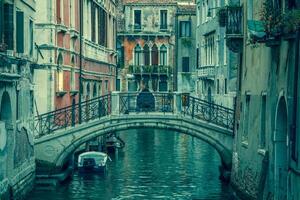 vista para um pequeno canal em veneza à noite foto