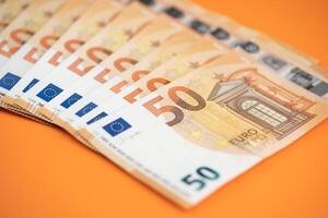 50. euro contas em a laranja fundo foto