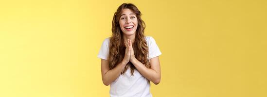 alegre fofa esperançoso menina apegado implorando Veja Câmera otimista fielmente pressione Palmeiras juntos orar súplica gesto Perguntando Favor suplicando desculpa positivo por sorte humor amarelo fundo foto