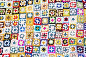 multi colori cobertor dentro lã, quadrado geométrico fundo, retro decorativo padronizar foto