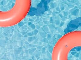 vermelho nadar argolas flutuando em brilhante piscina água foto