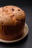 delicioso doce feriado Panettone bolo com entusiasmo e passas de uva em uma cerâmico prato foto