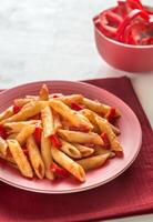 Macarrão Penne com tomate molho e fresco vermelho Pimenta foto