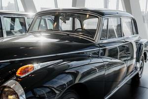 Da frente. grande carro retro preto polido perfeitamente. estacionado coberto na exposição de veículos foto