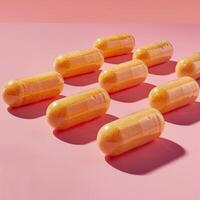 ai gerado laranja Vitamina pílulas arranjado em uma suave Rosa fundo dentro uma bem iluminado estúdio foto