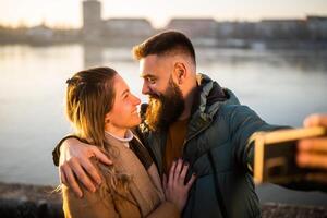 fechar acima imagem do feliz casal levando selfie ar livre. foto