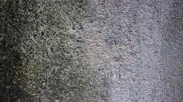 uma cinzento concreto parede com uma rude textura foto