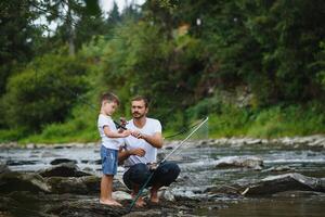 pai e filho pescaria. pai com dele filho em a rio desfrutando pescaria segurando pescaria varas foto