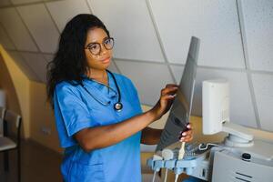 atraente fêmea africano americano médico profissional dentro escritório foto