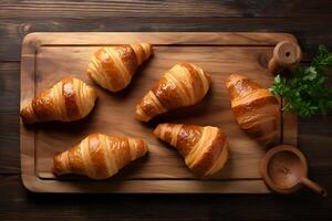 ai gerado croissants em uma corte borda em uma de madeira fundo, topo Visão foto