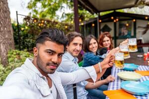 grupo do amigos tendo Diversão às jardim casa festa - jovem pessoas sorridente juntos bebendo Cerveja foto
