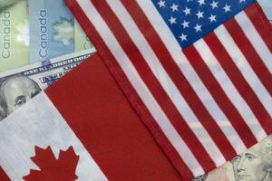 Unidos estados e canadense bandeiras em dólar e maluco moedas foto