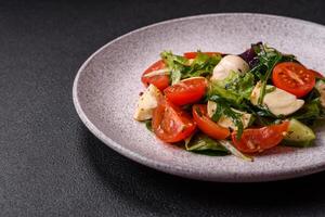 delicioso fresco caprese salada com mussarela, tomates, verduras com sal, especiarias e ervas foto