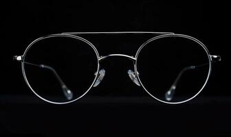 ai gerado Óculos isolado em uma Preto fundo. óculos com transparente vidro. foto