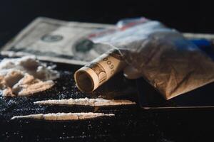 cocaína e dinheiro isolado em Preto fundo. foto