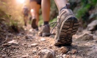 ai gerado caminhantes caminhando em uma trilha dentro a montanhas. fechar-se do uma par do caminhada sapatos foto