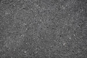 textura do Sombrio asfalto estrada com embutido rochas, urbano terra fundo. foto
