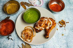 tandoori frango com Pimenta molho servido dentro uma prato isolado em cinzento fundo topo Visão do Bangladesh Comida foto