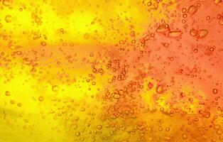 borbulhante brilho, vibrante gel fundo com abstrato textura dentro amarelo e laranja. foto
