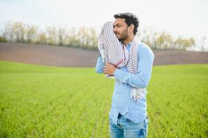 preocupação Menos ,indiano agricultor em pé dentro dele saudável trigo campo foto