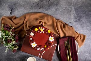 chocolate dourado renda bolo com rosa flores, faca e garfo servido em borda isolado em guardanapo topo Visão do cafeteria cozido Comida foto