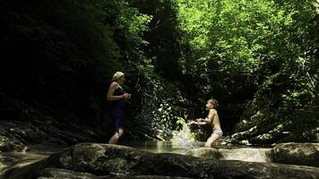 criança jogando dentro floresta rio em lindo verão dia. criativo. paraíso água reservatório dentro selvas. foto