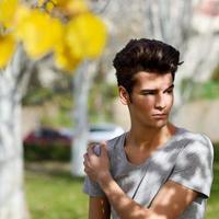 atraente jovem bonito, modelo da moda no parque foto