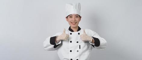 chef mulher asiática segurando um smartphone ou tablet digital e recebendo pedido on-line foto