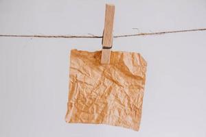 adesivos marrons no varal com prendedor de madeira, isolado no fundo branco. lugar para o seu texto foto