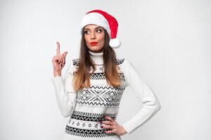 fechar acima retrato lindo caucasiano mulher dentro vermelho santa chapéu em branco estúdio fundo. Natal e Novo ano feriado conceito. foto