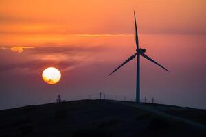 ai gerado vento turbina arreios limpar \ limpo energia no topo Colina durante pôr do sol foto