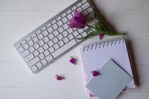 computador teclado e caderno com esvaziar folha. moderno ambiente de trabalho. foto