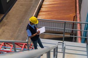 os engenheiros tomam nota das inspeções da planta industrial. foto