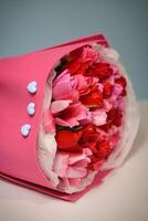 ramalhete do flores embrulhado dentro Rosa papel foto