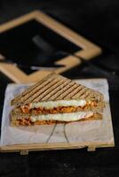 frango tikka hortelã grelhado sanduíche isolado em de madeira borda lado Visão do velozes Comida em Sombrio fundo foto