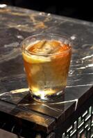 Padrinho, clássico beber com uísque uísque, amaretto e Amargas dentro uma vidro com gelo foto