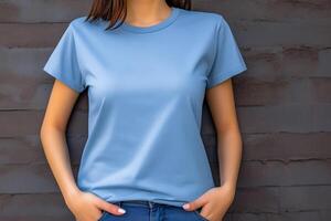 jovem mulher vestindo em branco azul camiseta dentro frente do a cinzento muro. brincar camiseta modelo. foto