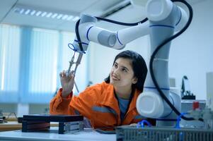 fêmea robótica engenheiro trabalhando com programação e manipulando robô mão, industrial robótica projeto, Alto tecnologia instalação, moderno máquina aprendizado. massa Produção automáticos. foto