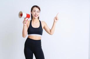 jovem ásia mulher vestindo roupa de esporte em branco fundo foto