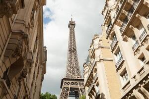 Paris, França 02 Junho 2018 pequeno Paris rua com Visão em a famoso Paris eifel torre em uma nublado verão dia com alguns brilho do sol foto