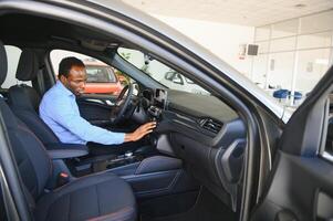 carro comprador. Preto cara escolhendo Novo automóvel dentro concessionária loja foto