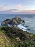 beira-mar às san Juan de gaztelugatxe dentro Espanha durante nascer do sol foto