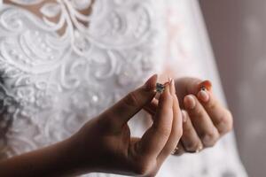 dama de honra preparando noiva para Casamento dia. dama de honra ajudando noiva apertar laço dela Casamento branco vestir antes cerimônia. luxo nupcial vestir fechar acima. Casamento manhã momentos detalhes conceito. foto